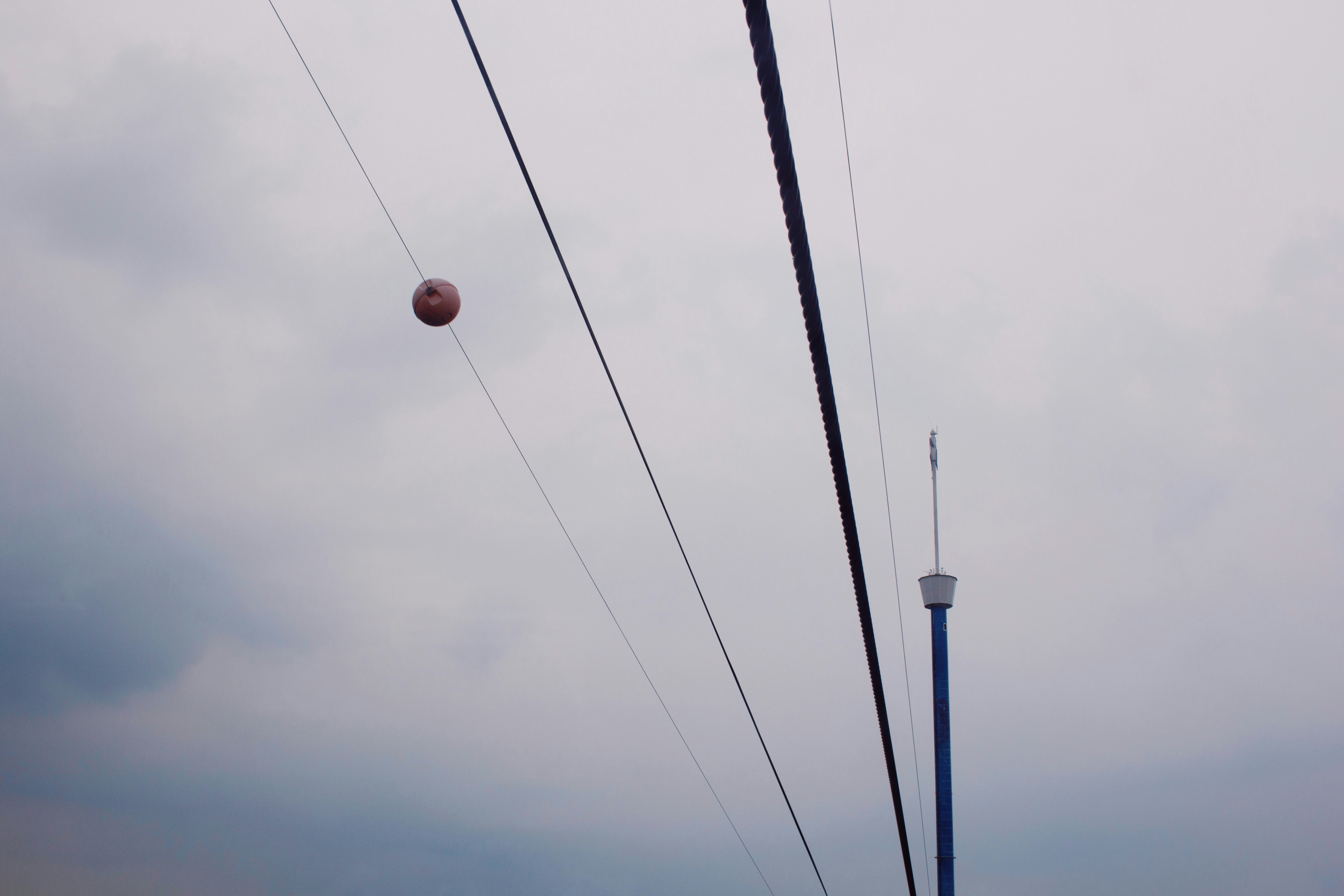 white and blue light post under cloudy sky during daytime